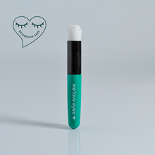 Load image into Gallery viewer, Teal eyelash extension tube with black cap on a light gray background, featuring 'we love eyes' branding.