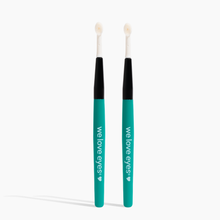 Load image into Gallery viewer, Two turquoise eyelid scrub brushes with black handles on a white background, branded 'we love eyes'.