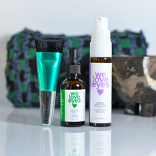 Load image into Gallery viewer, Four skincare products with 'we love eyes' branding on a reflective surface.
