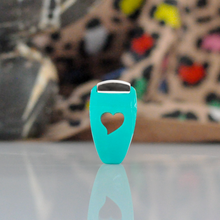 Load image into Gallery viewer, Turquoise bottle opener with heart design on a reflective surface, blurred background