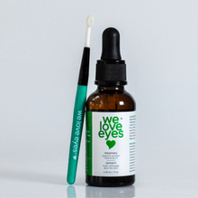 Load image into Gallery viewer, Bottle of 'we love eyes' eye care product with applicator on a light gray background

