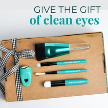 Load image into Gallery viewer, Eye care tool set with turquoise and black tools on a cardboard box labeled 'Toolbox'. Text 'Give the gift of clean eyes' above.
