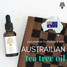 Load image into Gallery viewer, Bottle of 'we love eyes' tea tree oil with a checkered towel on a white background

